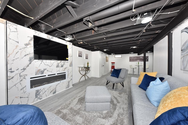 basement featuring a premium fireplace and light wood-type flooring