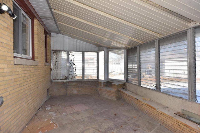 unfurnished sunroom with lofted ceiling