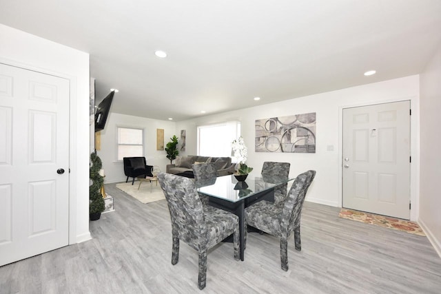 dining space with light hardwood / wood-style floors