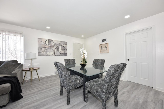 dining space featuring light wood-type flooring