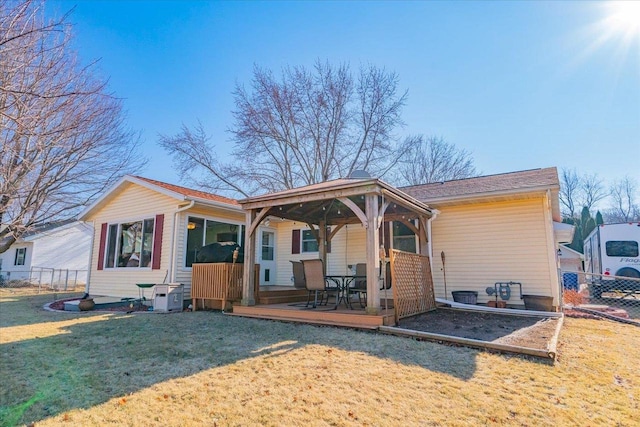 rear view of property with a yard