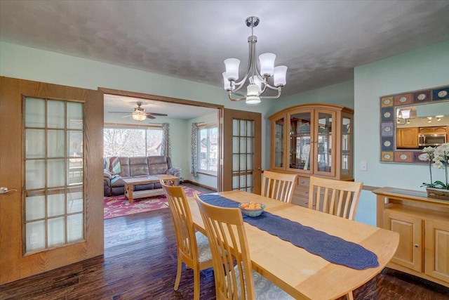 dining room featuring dark wood-type flooring and a notable chandelier