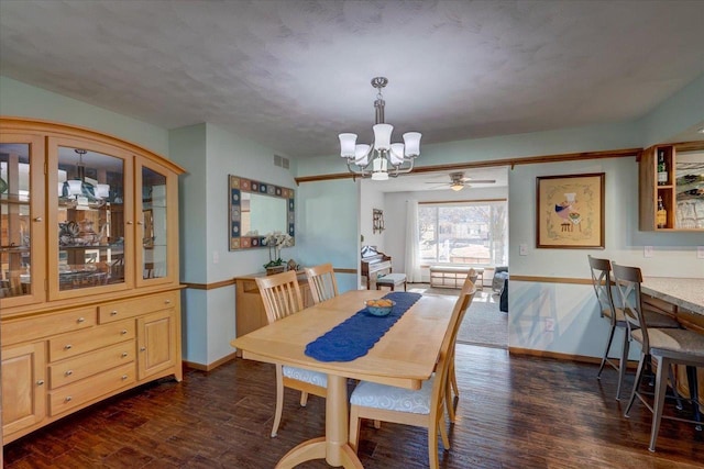 dining space featuring dark hardwood / wood-style flooring and a notable chandelier