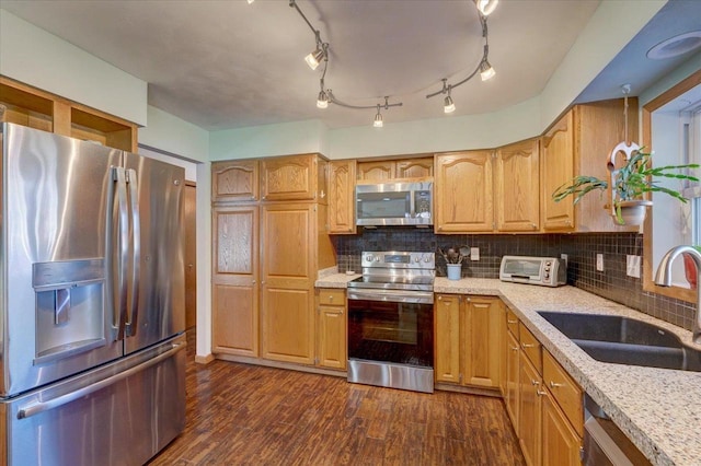 kitchen with dark wood-type flooring, sink, tasteful backsplash, appliances with stainless steel finishes, and light stone countertops