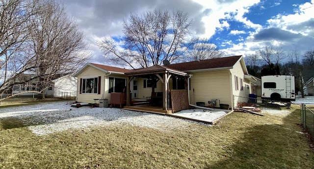 rear view of house featuring central AC unit and a yard