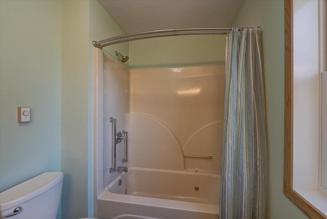 bathroom featuring shower / bathtub combination with curtain and toilet