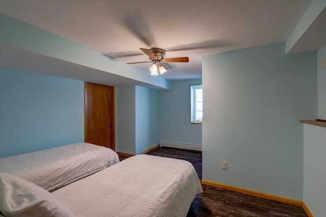 bedroom with ceiling fan, a baseboard heating unit, and dark hardwood / wood-style floors