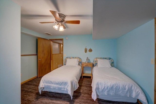 bedroom with dark hardwood / wood-style floors and ceiling fan