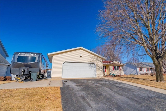 view of front of home featuring a garage and a front lawn