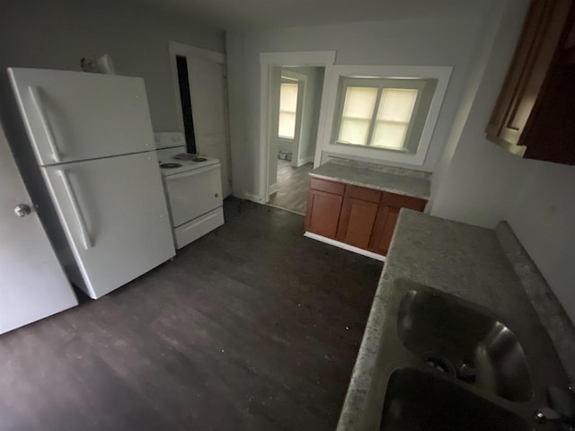 kitchen with dark hardwood / wood-style flooring, sink, and white appliances