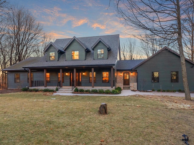 view of front of property with a lawn and covered porch