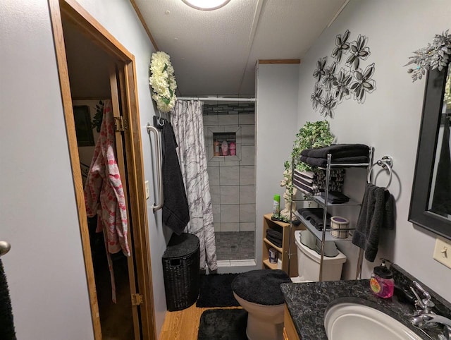 bathroom featuring vanity, wood-type flooring, a textured ceiling, curtained shower, and toilet