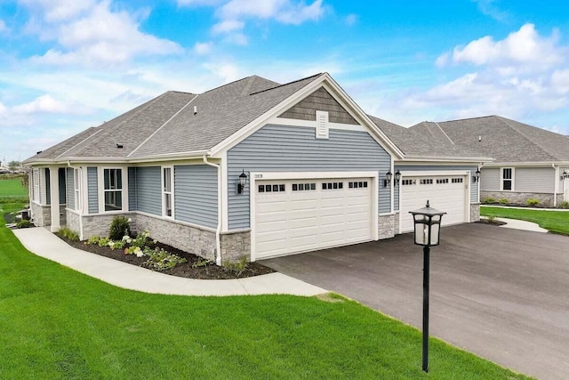 view of front of property with a garage and a front lawn