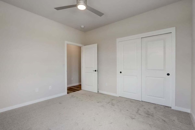 unfurnished bedroom featuring ceiling fan, carpet floors, and a closet