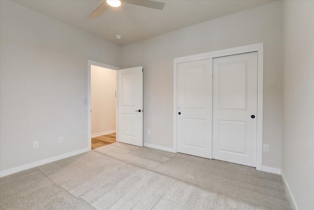 unfurnished bedroom featuring carpet flooring, ceiling fan, and a closet