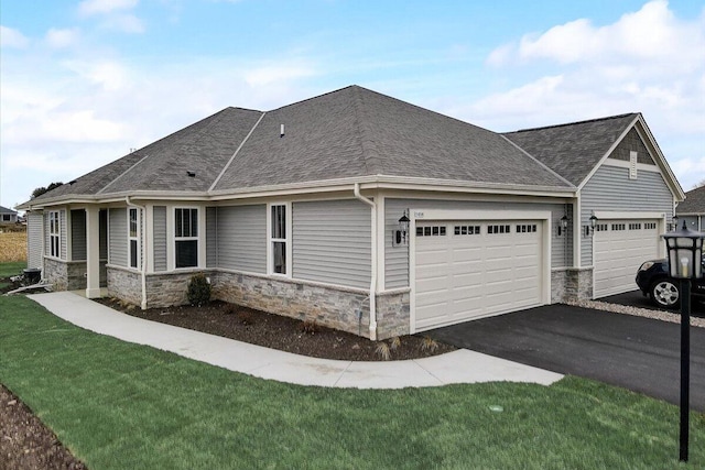 view of side of home with a yard and a garage