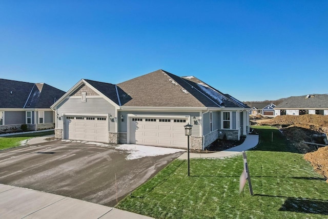 view of front of house with a garage and a front lawn