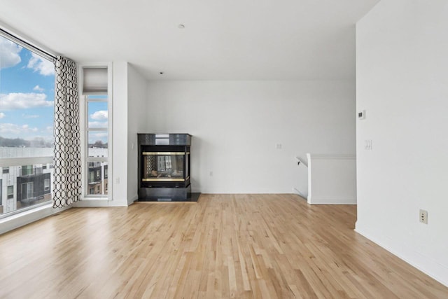 unfurnished living room with light hardwood / wood-style flooring