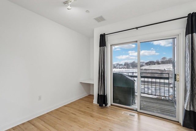 spare room featuring light wood-type flooring