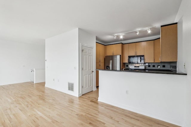 kitchen featuring stainless steel fridge with ice dispenser, tasteful backsplash, light hardwood / wood-style floors, kitchen peninsula, and track lighting