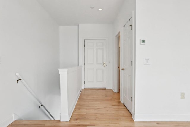 hallway with light hardwood / wood-style flooring