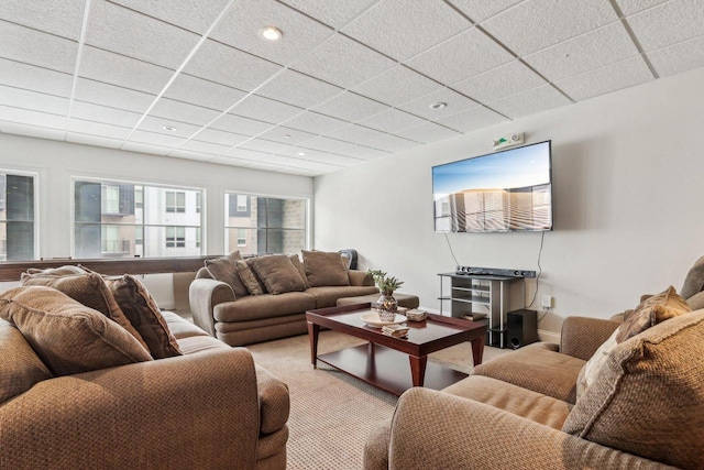 carpeted living room featuring a paneled ceiling