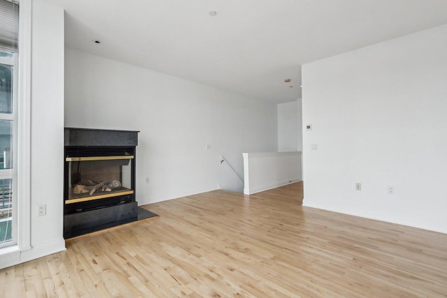 unfurnished living room with light hardwood / wood-style floors