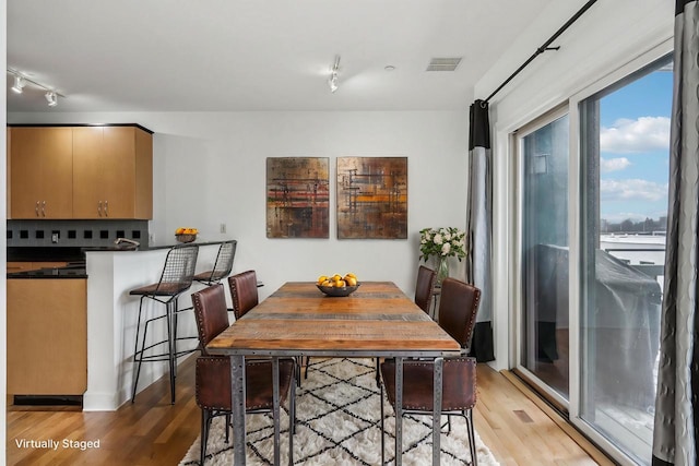 dining room with light hardwood / wood-style flooring