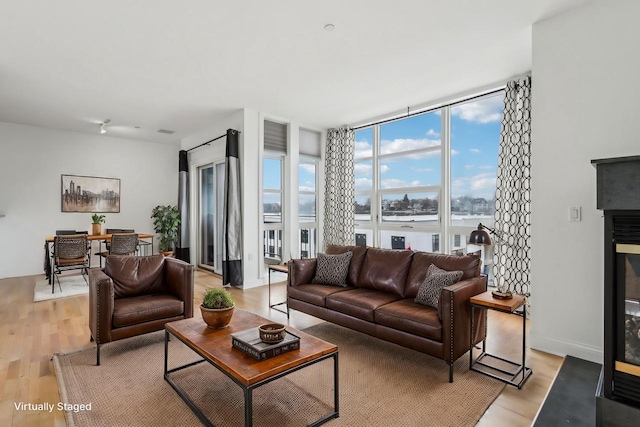 living room featuring floor to ceiling windows and light wood-type flooring