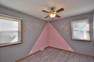 spare room featuring ceiling fan, light hardwood / wood-style floors, and a wealth of natural light