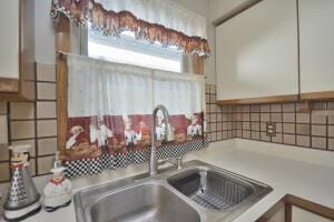 room details featuring white cabinetry and sink