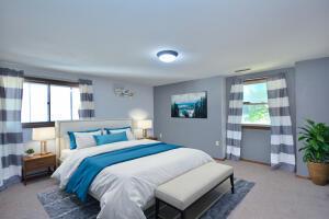 carpeted bedroom featuring multiple windows