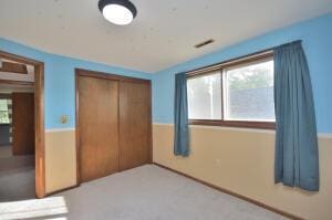 unfurnished bedroom with a closet