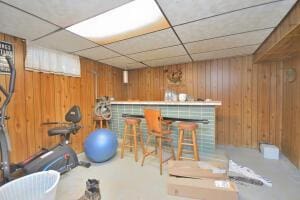 interior space featuring wooden walls and bar area