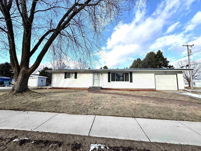 single story home featuring a garage and a front yard