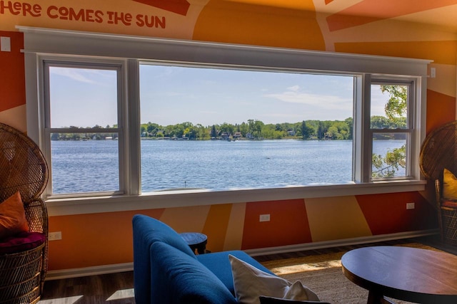 interior space with a water view and hardwood / wood-style flooring