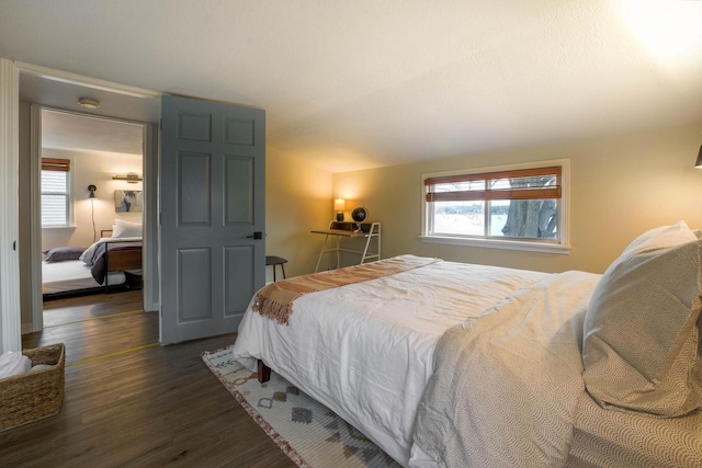 bedroom with dark hardwood / wood-style floors