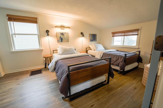 bedroom featuring lofted ceiling and wood-type flooring