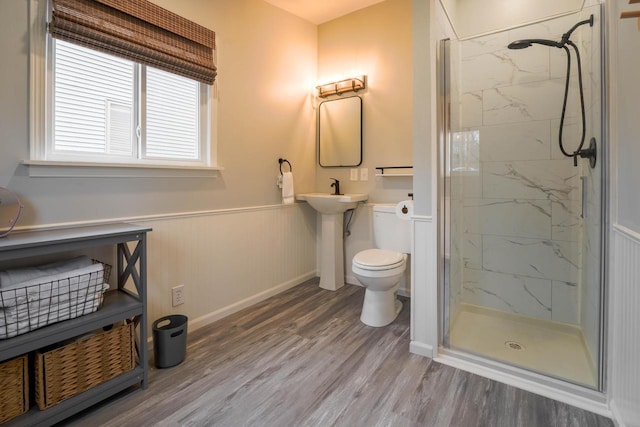 bathroom with sink, wood-type flooring, a shower with door, and toilet