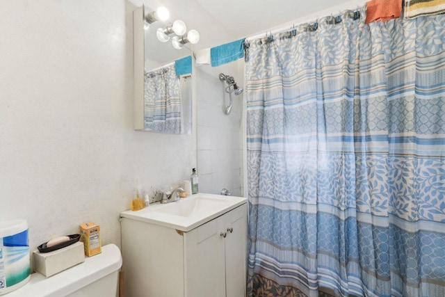 bathroom with vanity, curtained shower, and toilet