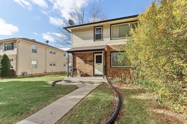 view of property featuring a front lawn