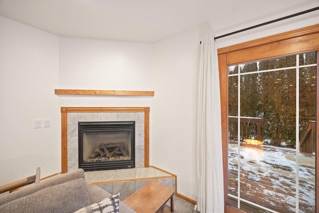 living room with carpet flooring and a tile fireplace