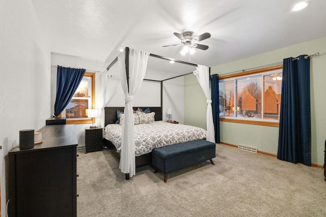 bedroom featuring ceiling fan and light colored carpet