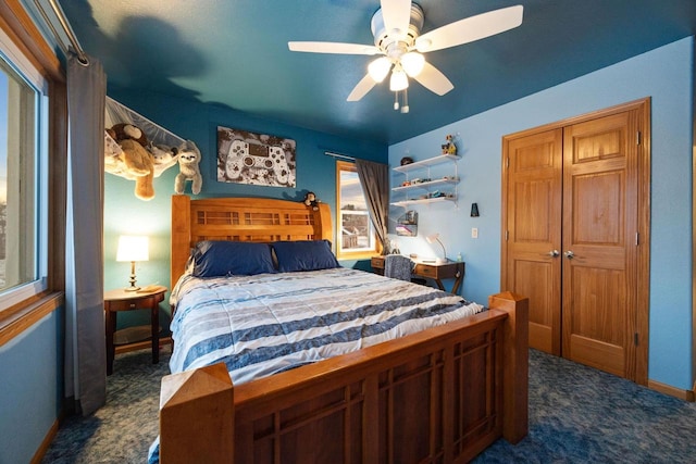 bedroom featuring dark carpet, a closet, and ceiling fan