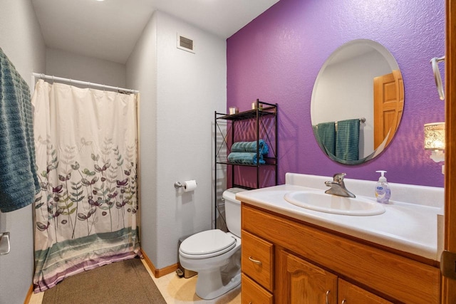 bathroom with vanity, toilet, and walk in shower