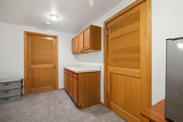 kitchen featuring light colored carpet