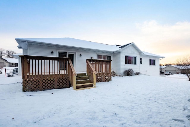 snow covered property featuring a wooden deck