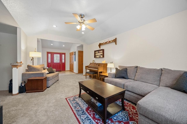 living room featuring vaulted ceiling, light colored carpet, and ceiling fan