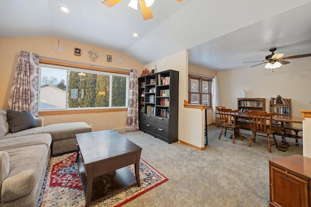 living room featuring ceiling fan, light colored carpet, and lofted ceiling