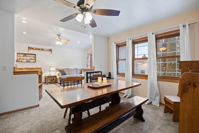 carpeted dining space featuring vaulted ceiling